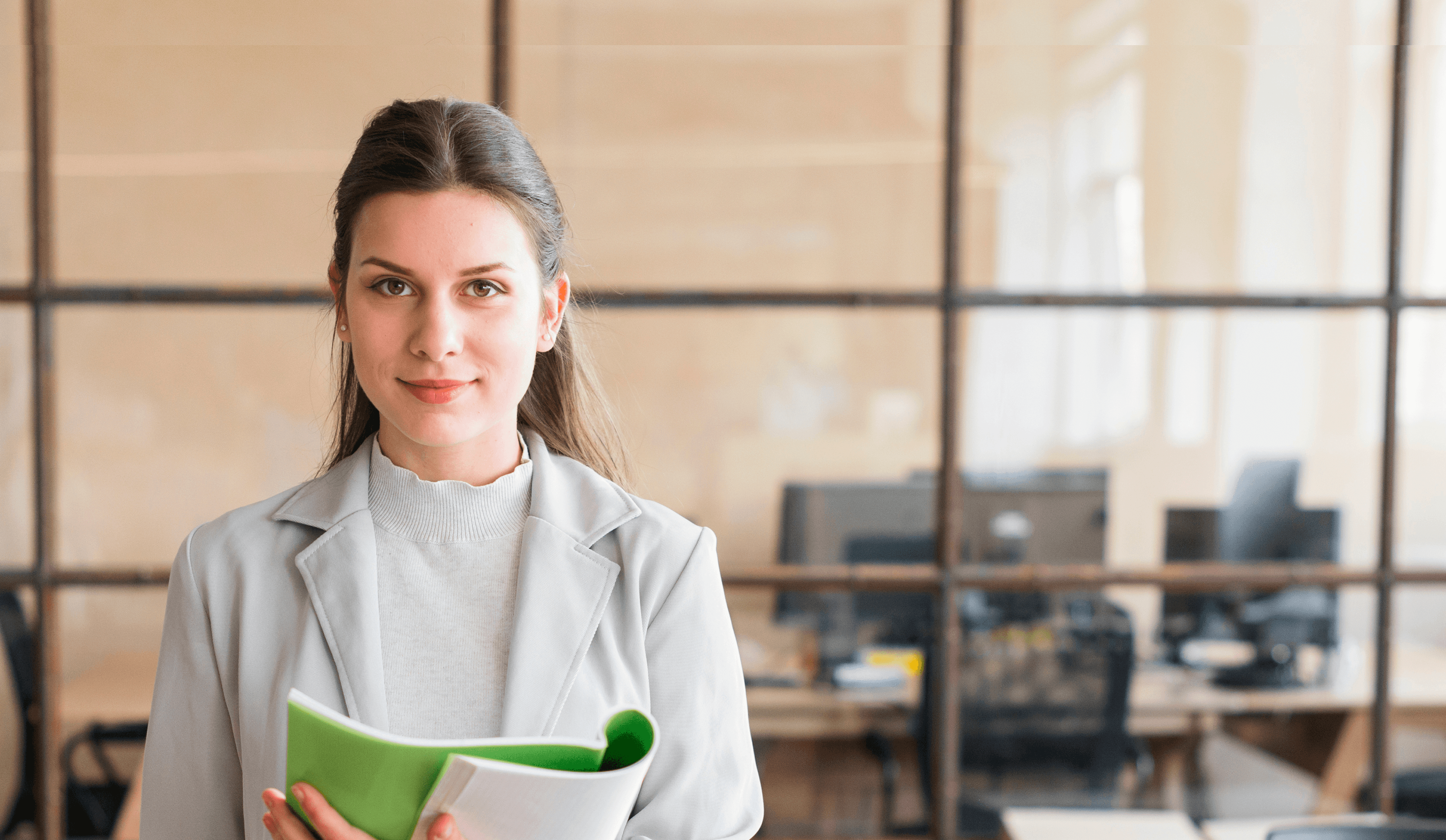 Professional woman holding a folder in a modern office